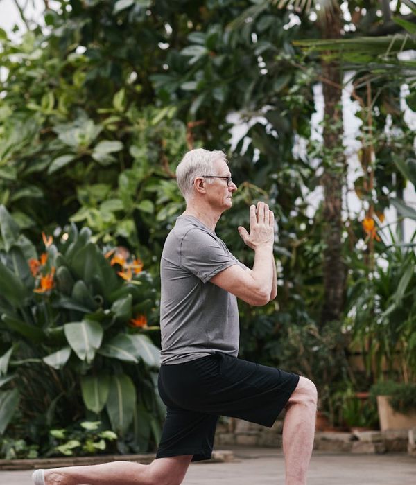 A man meditating outdoors at sunrise, embodying peace and well-being.